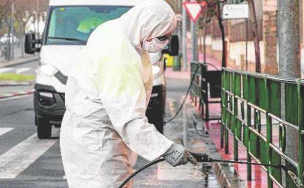 Un operario de limpieza desinfectando el mobiliario ubano para evitar el contagio del coronavirus. 